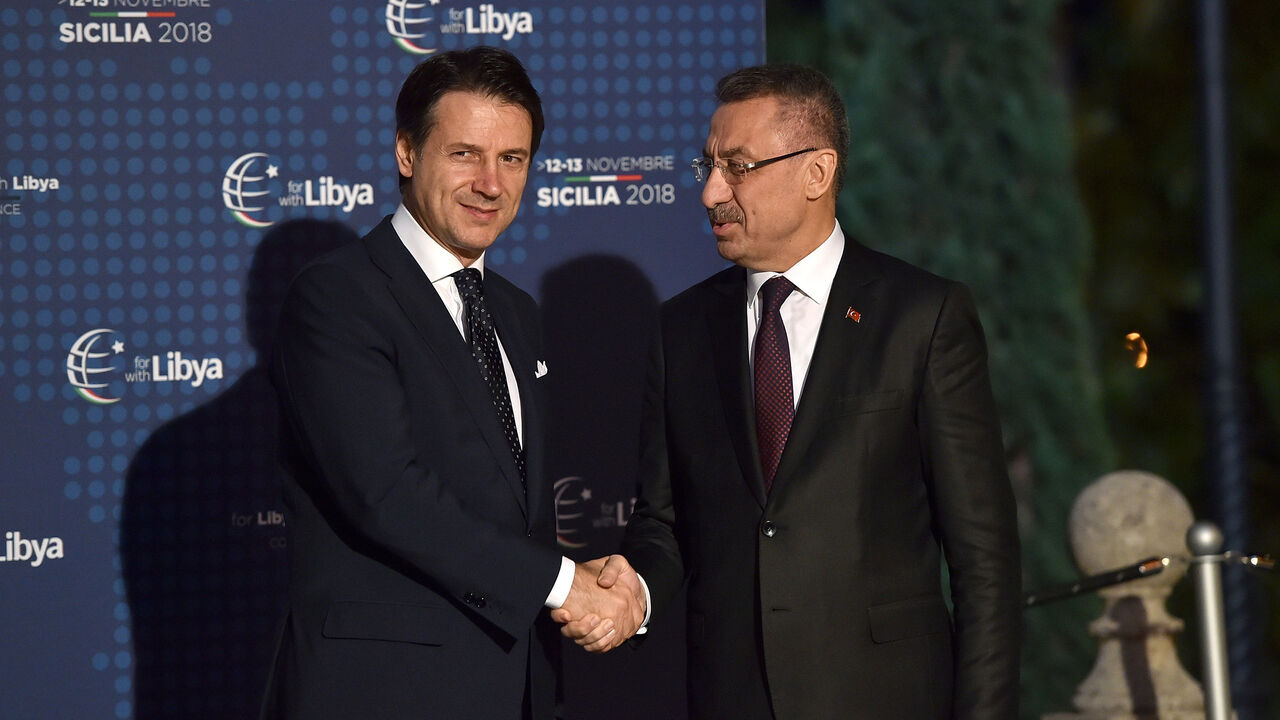 775255632TP104_The_Conferen PALERMO, ITALY - NOVEMBER 12: Italian Prime Minister Giuseppe Conte welcomes Fuat Oktay, Vice President of Turkey during the Conference for Libya at Villa Igiea on November 12, 2018 in Palermo, Italy. Heads of State, ministers and special envoys are holding a two day meeting where they will discuss about security and stability in Libya. (Photo by Tullio Puglia/Getty Images)
