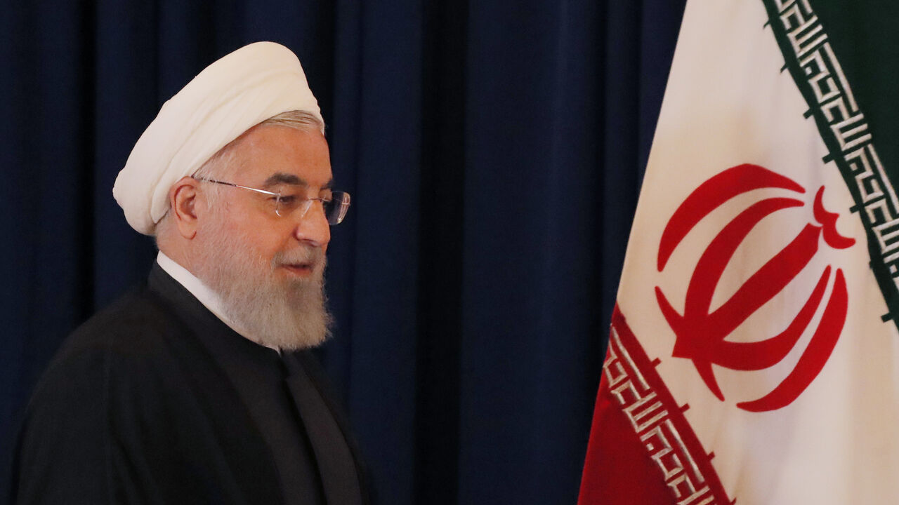 UN-ASSEMBLY/ Iran's President Hassan Rouhani walks by his country's flag at a news conference on the sidelines of the 73rd session of the United Nations General Assembly at U.N. headquarters in New York, U.S., September 26, 2018. REUTERS/Brendan Mcdermid - HP1EE9Q1DYAGU