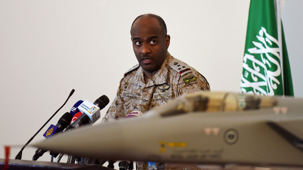 Nic6433179 Saudi Brigadier General Ahmed Asiri, spokesman of the Saudi-led coalition forces, speaks to the media next to a replica of a Tornado fighter jet, at the Riyadh airbase in the Saudi capital on March 26, 2014. Speaking to reporters in the Saudi capital, spokesman Ahmed Assiri also said that there were no immediate plans for a ground offensive but that the coalition would not allow any supplies to reach the rebels. AFP PHOTO / FAYEZ NURELDINE (Photo credit should read FAYEZ NURELDINE/AFP/Getty Images)