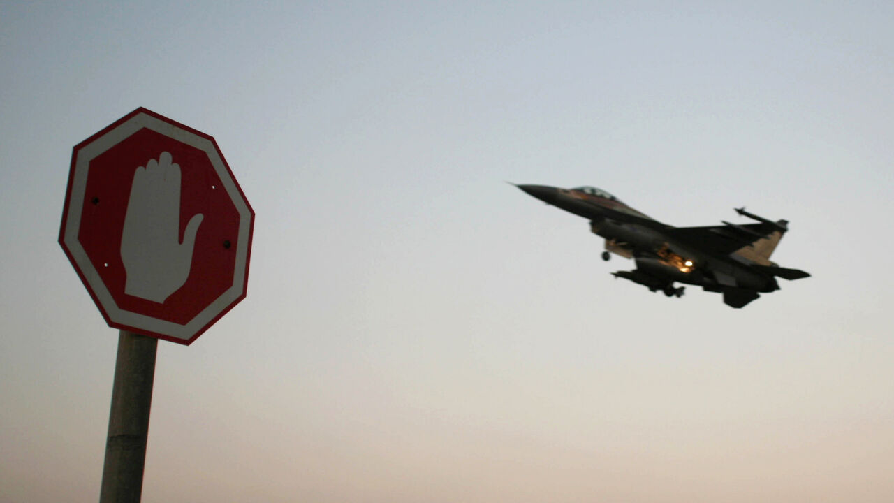 SYRIA-ISRAEL/ An Israeli Air Force F-16 fighter plane flying above a traffic sign after taking off for a mission in Lebanon from an Israeli Air Force Base in northern Israel in this July 20, 2006 file photo. Israeli warplanes bombed unidentified Syrian targets early on September 6, 2007, causing no damage or casualties, the official Syrian news agency said. Syrian air defences fired at the incoming planes, which crossed into Syria after midnight local time, the agency said. REUTERS/Ammar Awad/Files (ISRAEL) - GM1DWCBQYXA