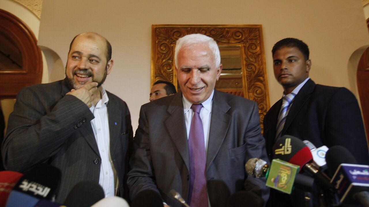Egypt Azzam al-Ahmad (L), head of the Fatah group, and Mousa Abu Marzook (C), a senior member of Hamas, speak after a news conference in Cairo April 27, 2011. Palestinian President Mahmoud Abbas's Fatah group has inked a deal with bitter rival Hamas to end their long-running feud and form an interim government ahead of elections this year, officials said on Wednesday. REUTERS/Asmaa Waguih (EGYPT - Tags: POLITICS) - GM1E74S0BG101