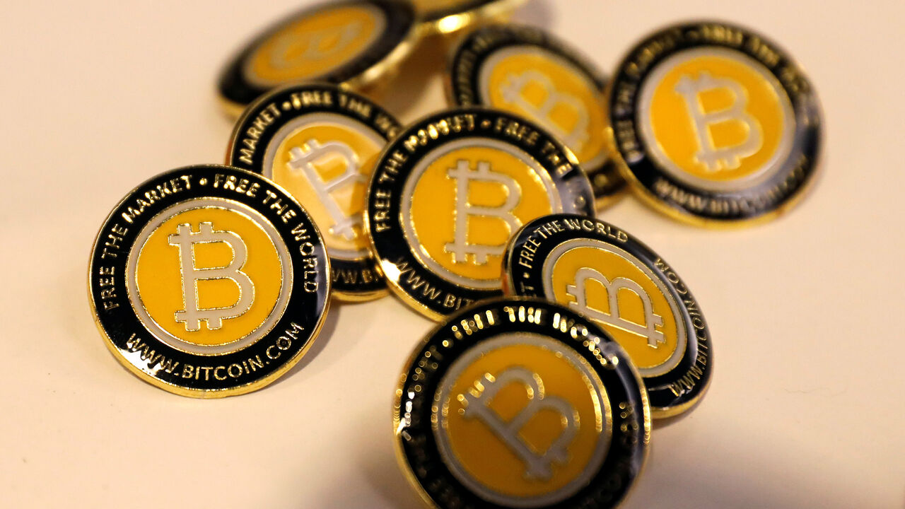 CRYPTO-CURRENCIES/CONSENSUS Bitcoin.com buttons are seen displayed on the floor of the Consensus 2018 blockchain technology conference in New York City, New York, U.S., May 16, 2018. REUTERS/Mike Segar - RC1B17B79620