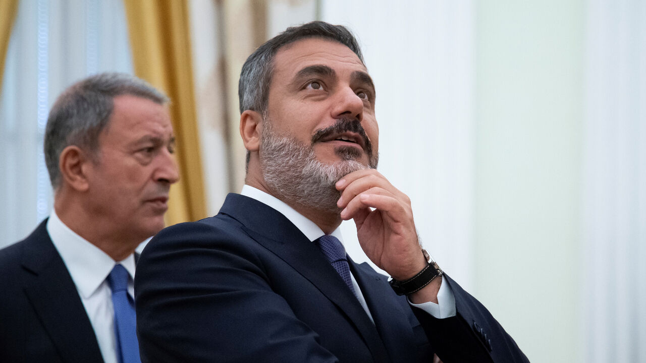 MIDEAST-CRISIS/SYRIA-TURKEY-RUSSIA-PROPOSAL Turkish Defense Minister Hulusi Akar and intelligence chief Hakan Fidan are seen before a meeting with Russian President Vladimir Putin in the Kremlin in Moscow, Russia August 24, 2018. Alexander Zemlianichenko/Pool via REUTERS - RC1992C13F10