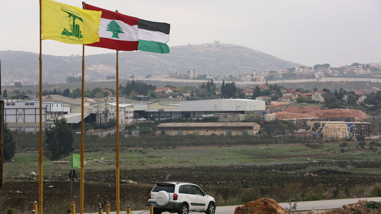 Flags of Hezbollah, Lebanon and Palestine are seen fluttering near the border with Israel in the village of Khiam, Lebanon December 4, 2018. REUTERS/Ali Hashisho - RC1797CA76B0