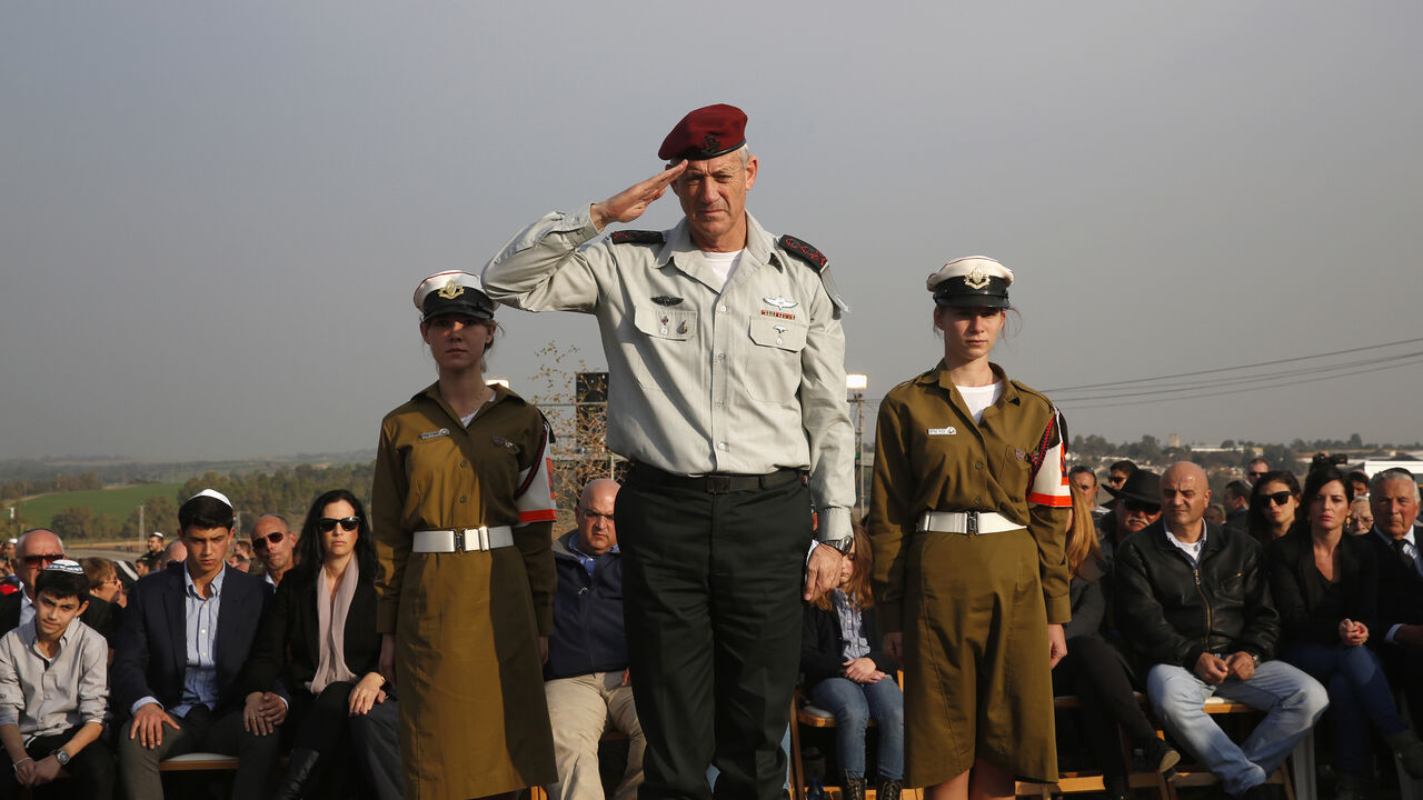 ISRAEL-SHARON/ Israel's military chief Lieutenant-General Benny Gantz salutes in front of the grave of former Israeli Prime Minister Ariel Sharon during his funeral near Sycamore Farm, Sharon's residence in southern Israel, January 13, 2014. Israel buried Sharon at his family farm on Monday, celebrating the military achievements of a man seen as a war hero at home but as a war criminal by many in the Arab world. Sharon, 85, died on Saturday after spending the last eight years of his life motionless in a hospital bed, pitc