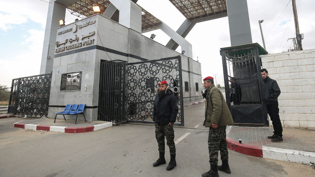 AFP_1C25PT Palestinian security forces loyal to Hamas stand guard at the Rafah border crossing with Egypt, in the southern Gaza Strip, on January 8, 2019. - The Egyptian border crossing was closed for Palestinians seeking to leave Gaza on Tuesday, a border official said, as infighting between Palestinian factions increases. (Photo by SAID KHATIB / AFP) (Photo credit should read SAID KHATIB/AFP/Getty Images)