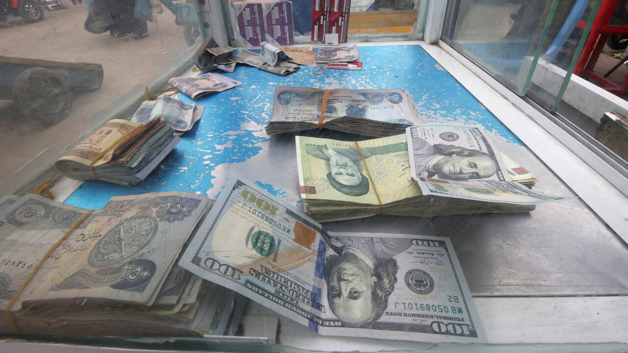 USA-IRAN/SANCTIONS-IRAQ Iranian rials, U.S. dollars and Iraqi dinars are seen at a currency exchange shop in Basra, Iraq November 3, 2018. Picture taken November 3, 2018. REUTERS/Essam al-Sudani - RC1645948610