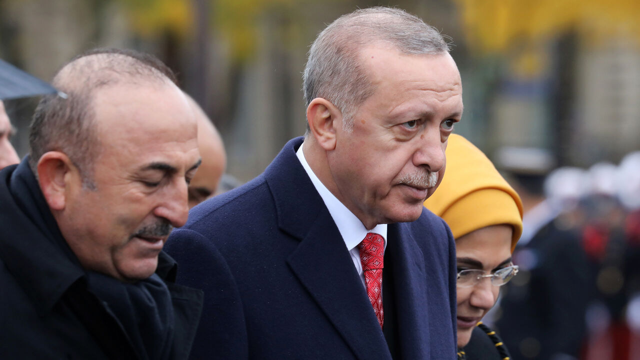 WW1-CENTURY/FRANCE-CEREMONY Turkish President Recep Tayyip Erdogan and Turkish Foreign Minister Mevlut Cavusoglu leave a commemoration ceremony for Armistice Day, 100 years after the end of the First World War, at the Arc de Triomphe, in Paris, France, November 11, 2018. Ludovic Marin/Pool via REUTERS - RC14BD6A5800