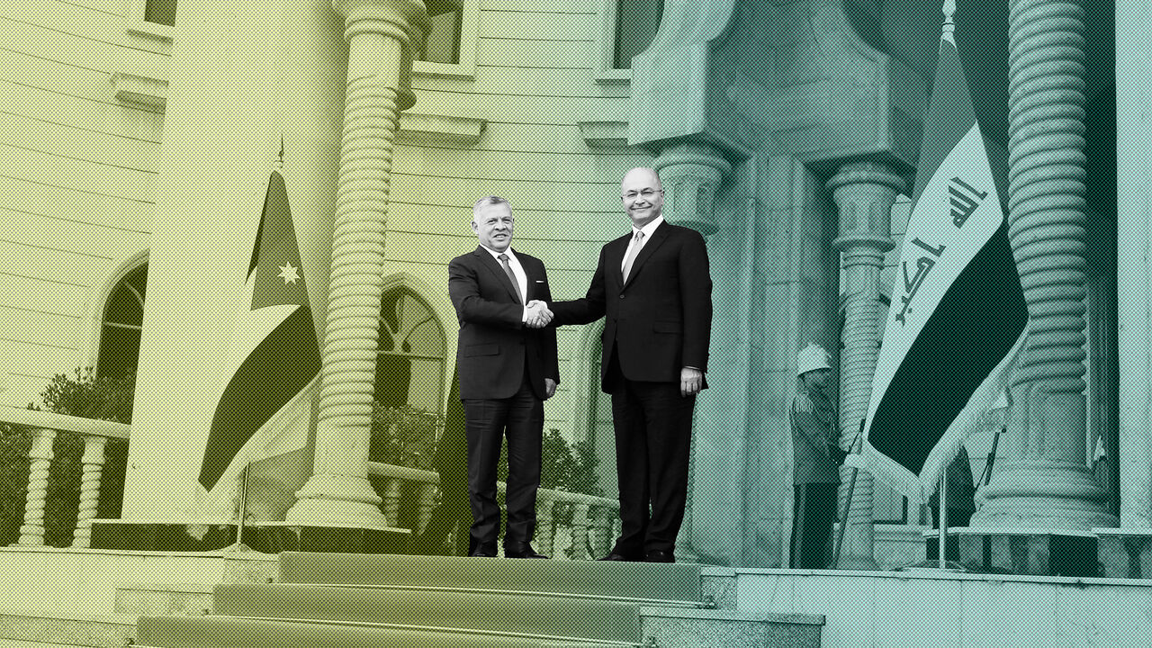 IRAQ-JORDAN/ Jordan's King Abdullah shakes hands with Iraq's President Barham Saleh, during his visit in Baghdad, Iraq January 14, 2019. REUTERS/Khalid Al-Mousily - RC1266A21620