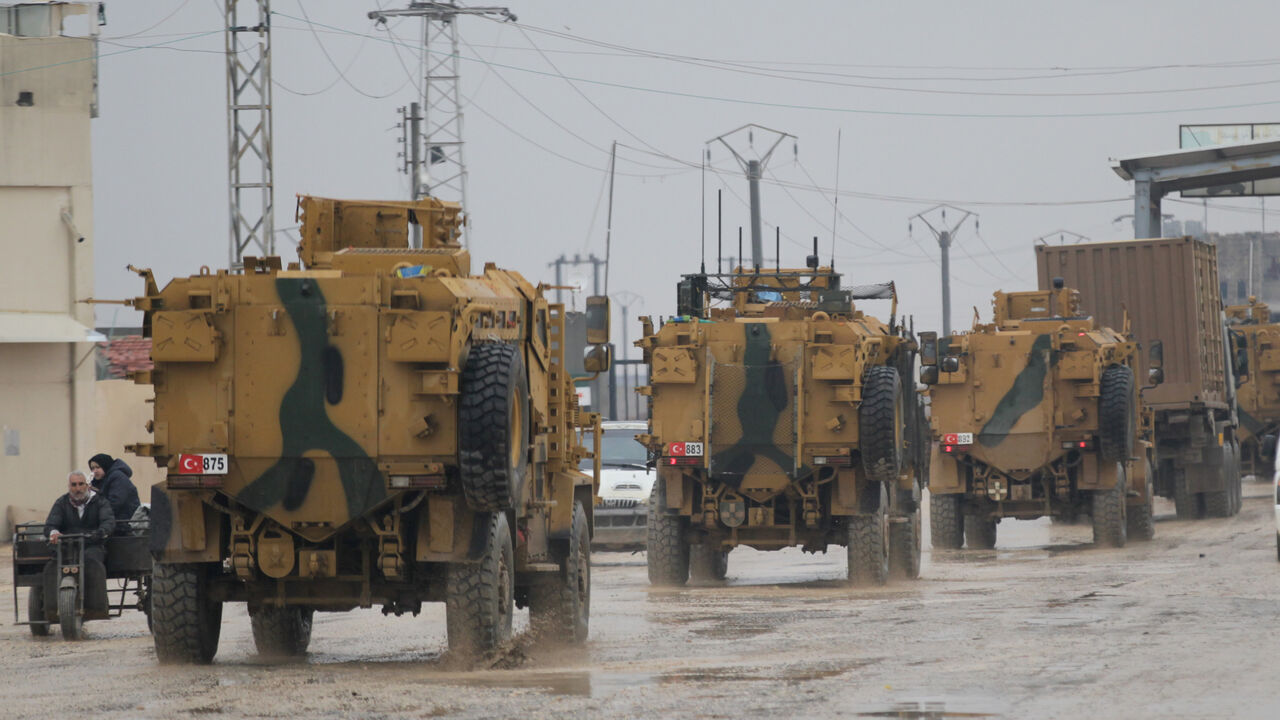 MIDEAST-CRISIS/SYRIA-REBELS Turkish military vehicles ride at the Bab el-Salam border crossing between the Syrian town of Azaz and the Turkish town of Kilis, in Syria January 1, 2019. Picture taken January 1, 2019. REUTERS/Khalil Ashawi - RC1AD1B9E6A0