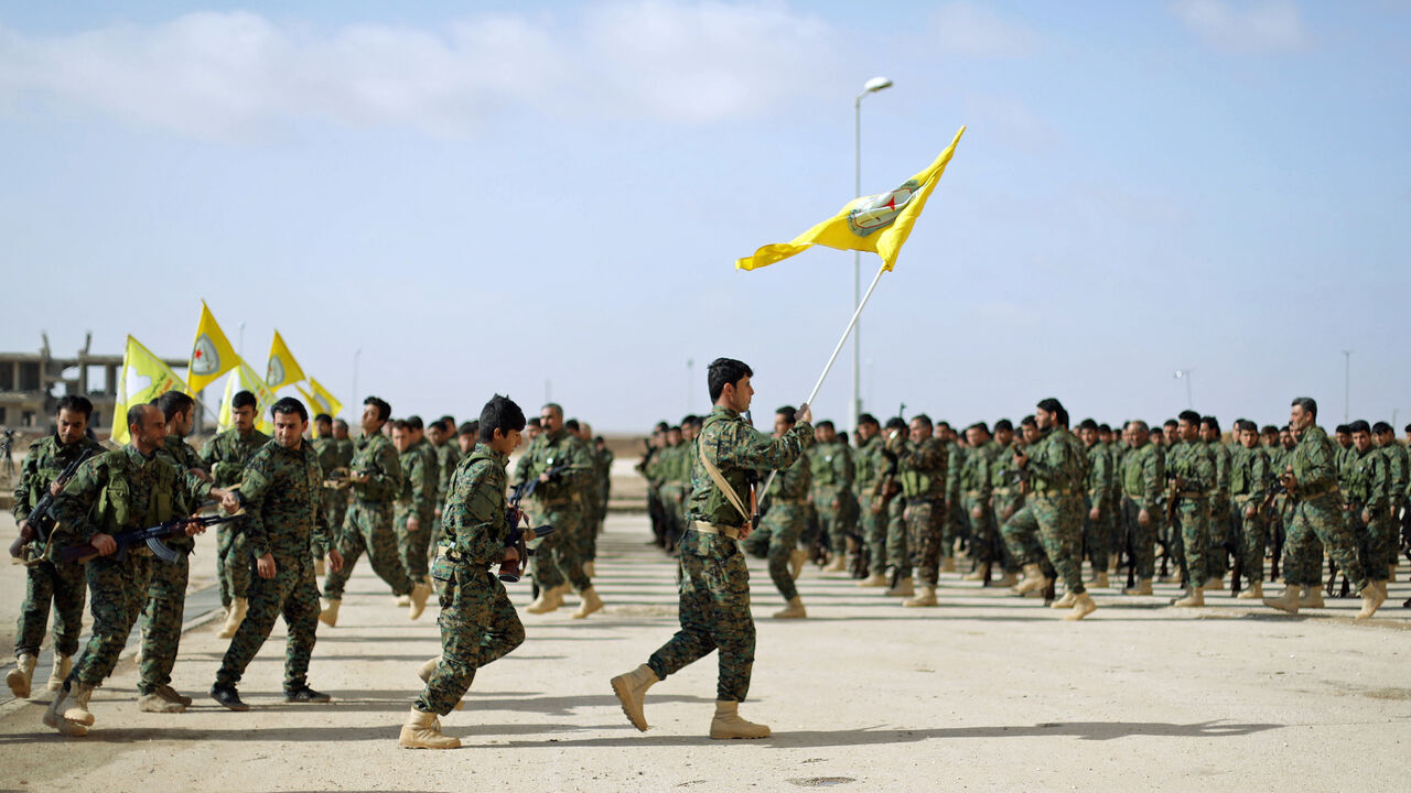 MIDEAST-CRISIS/SYRIA Fighters from a new border security force under the command of Syrian Democratic Forces (SDF) hold flags during a graduation ceremony in Hasaka, northeastern Syria, January 20, 2018. REUTERS/Rodi Said - RC1CD85096E0
