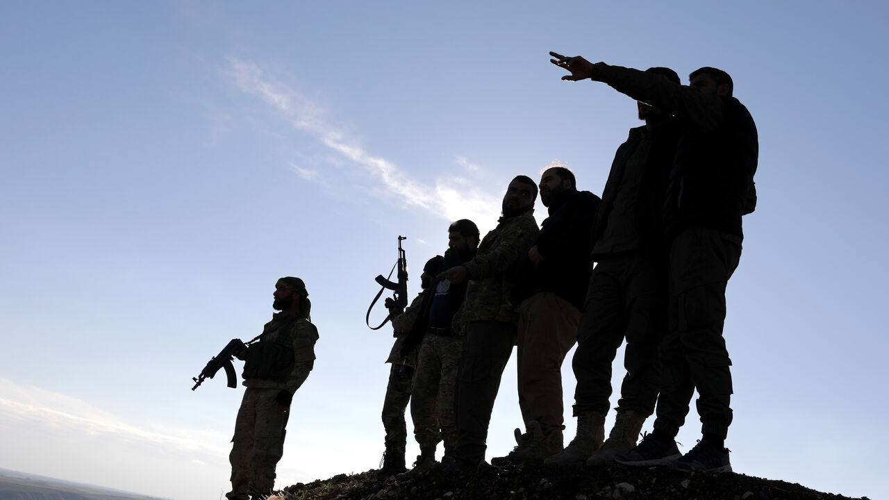 MIDEAST-CRISIS/SYRIA-YPG Turkish-backed Syrian rebels stand with their weapons at Manbij countryside, Syria December 29, 2018. REUTERS/Khalil Ashawi - RC1C44664B70