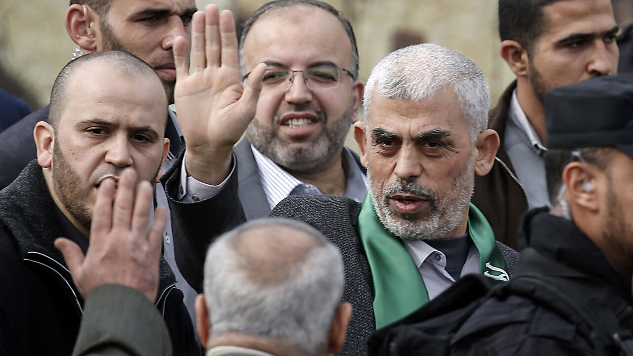AFP_1BN3RX Hamas' leader in the Gaza Strip Yahya Sinwar (1st-R) waves upon his arrival at a rally marking the 31st anniversary of Hamas' founding, in Gaza City December 16, 2018. (Photo by SAID KHATIB / AFP) (Photo credit should read SAID KHATIB/AFP/Getty Images)