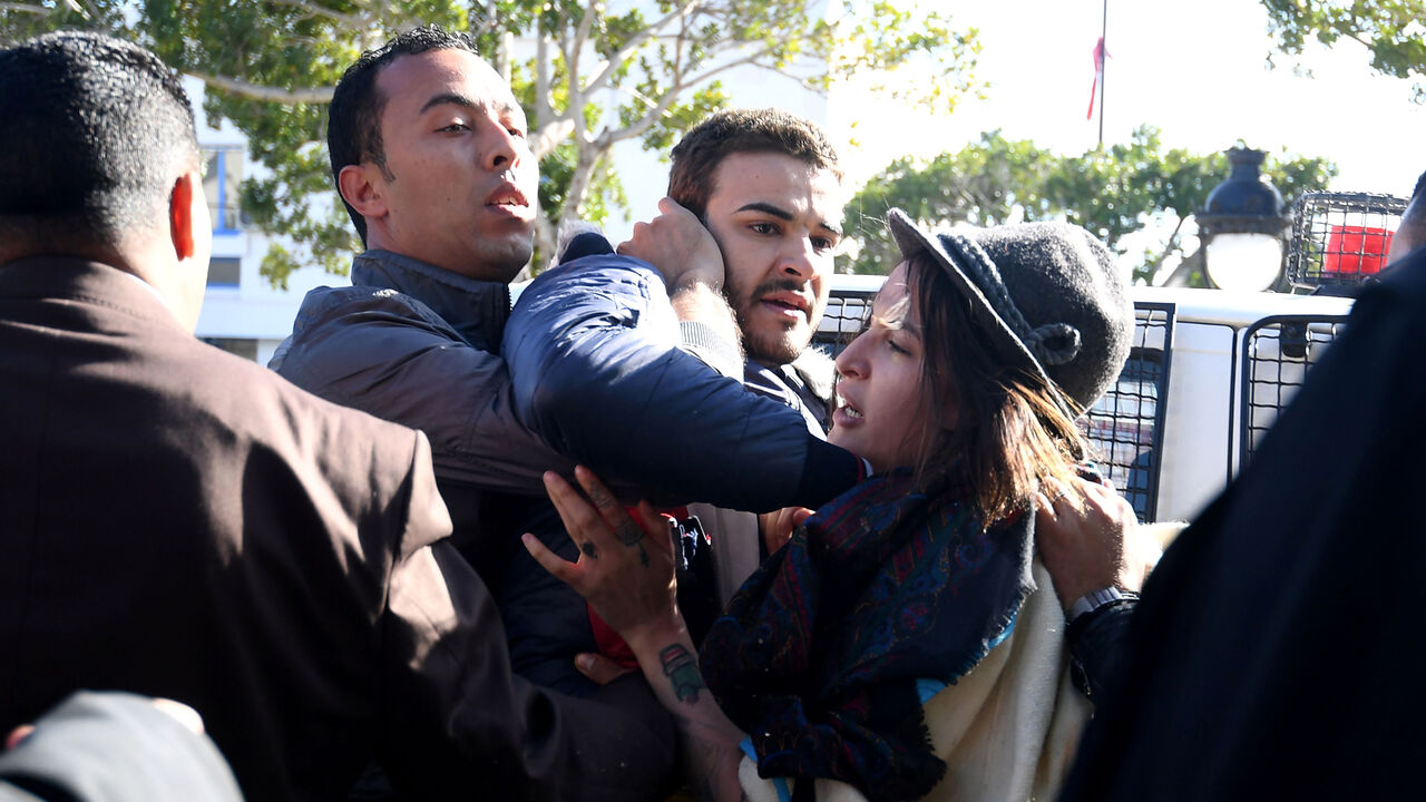 AFP_Y13EK Policemen in plain clothes force LGBT activists Radio Shams host, Fares Hadj Amor (C) and Femen's Amina Sboui into a vehicle as they disperse a protest in Tunis on January 27, 2018.
A call had been made to protest outside the tourism ministry under the hashtag "#Sayebni" ("Let me go") to demand the repeal of "retrograde" laws and the end of "the criminalisation of sexual freedom and discrimination against women". / AFP PHOTO / FETHI BELAID (Photo credit should read FETHI BELAID/AFP/Getty Images)
