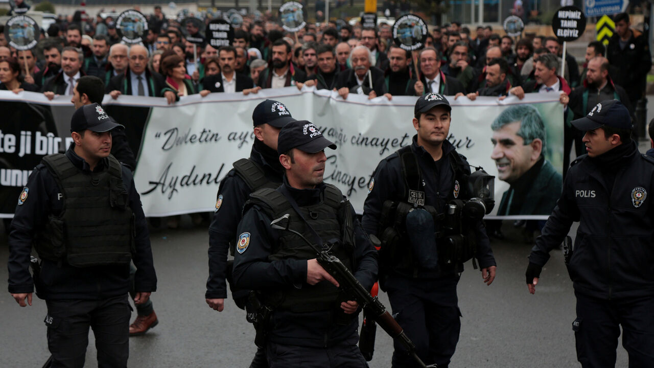 TURKEY-KURDS/LAWYER Riot police lead a group of lawyers gathering in Sur district to commemorate the late Diyarbakir Bar Association President Tahir Elci on the third anniversary of his death from gunshot wounds, in Diyarbakir, Turkey November 28, 2018. REUTERS/Sertac Kayar - RC1666DBA450