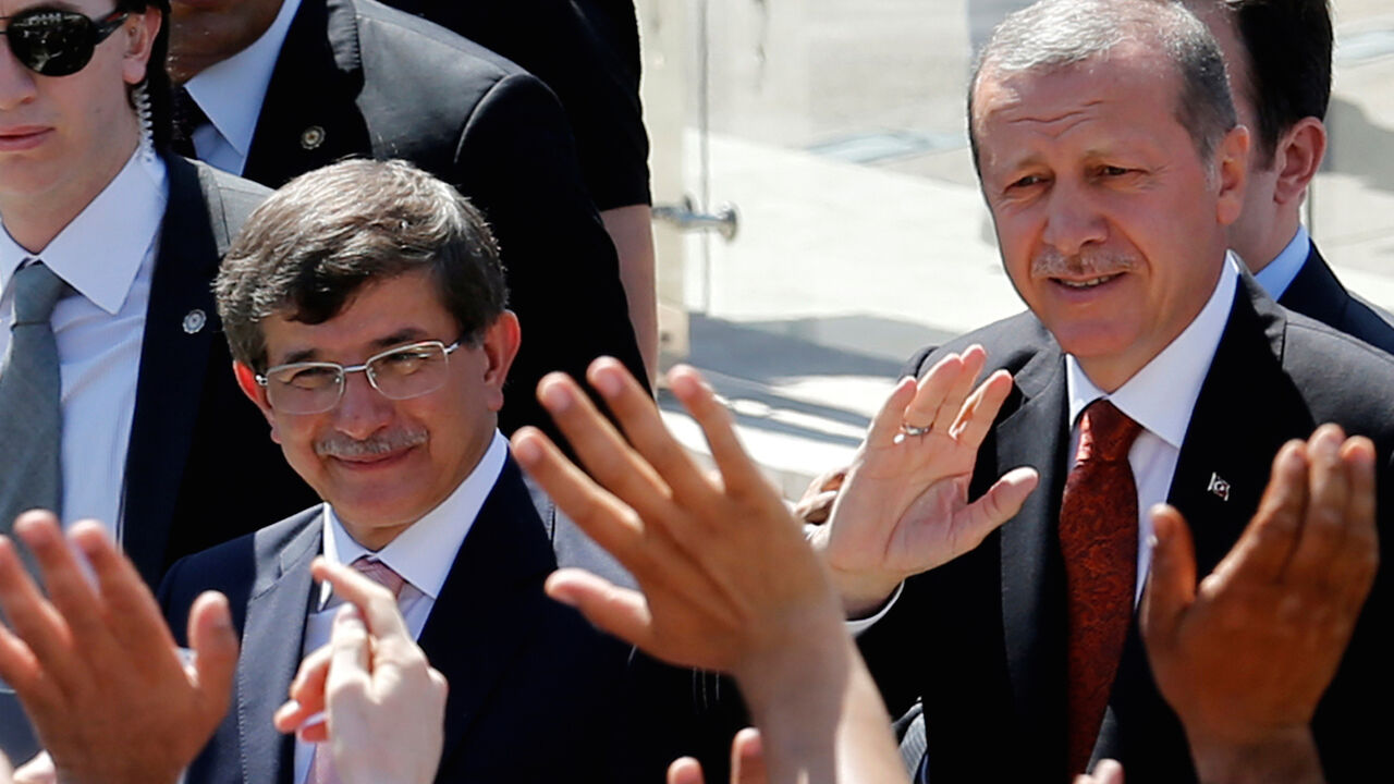 TURKEY-POLITICS/ Turkey's then-Prime Minister Tayyip Erdogan (R) and then-Foreign Minister Ahmet Davutoglu greet their supporters as they leave Friday prayers in Ankara, Turkey, August 22, 2014. REUTERS/Umit Bektas/File Photo - D1AETCCKOAAA