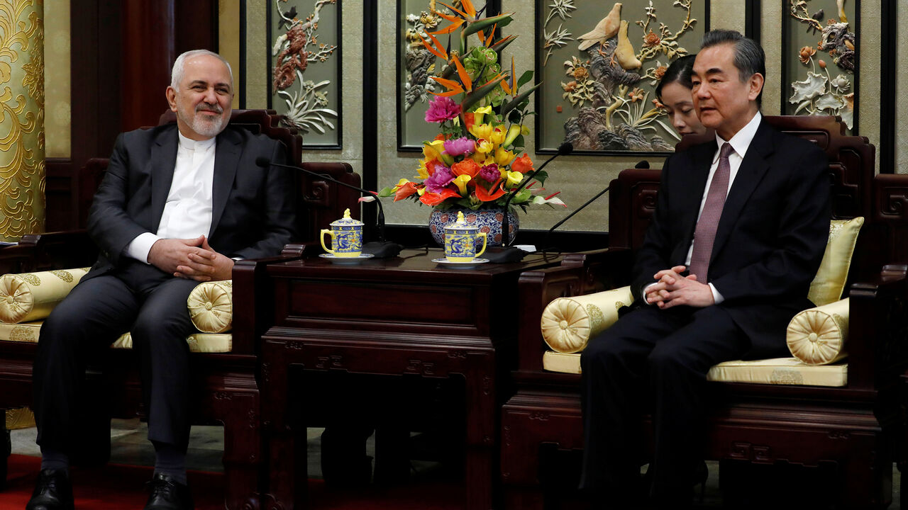 CHINA-IRAN/ Iranian Foreign Minister Mohammad Javad Zarif (L) and his Chinese counterpart Wang Yi chat during their meeting at the Diaoyutai State Guesthouse in Beijing, China February 19, 2019. How Hwee Young/Pool via REUTERS - RC181062C080