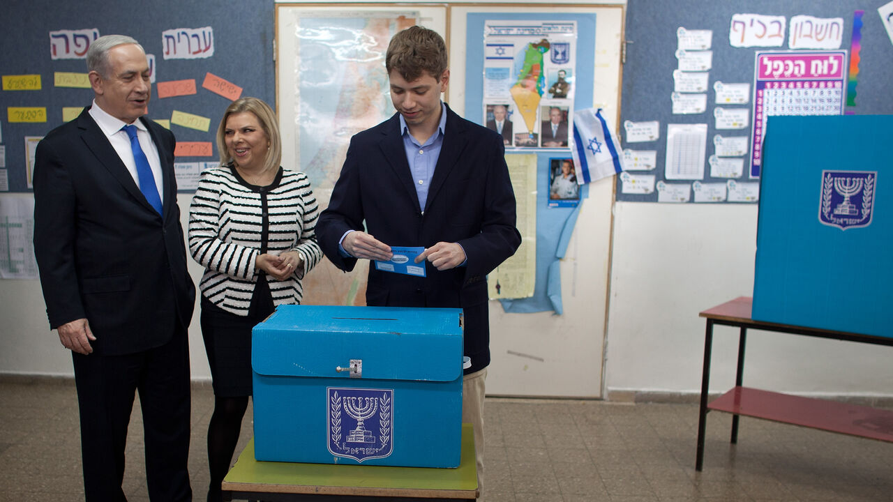 72976434 JERUSALEM, ISRAEL - JANUARY 22: (ISRAEL OUT) Israeli Prime Minister Benjamin Netanyahu watches his son Yair Netanyahu cast his ballot with by wife Sara Netanyahu at a polling station on election day on January 22, 2013 in Jerusalem, Israel. Israel's general election voting has begun today as polls show Netanyahu is expected to return to office with a narrow majority. (Photo by Uriel Sinai/Getty Images)