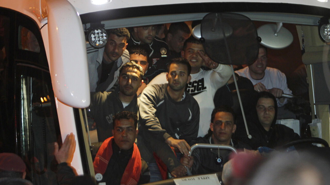Newly released Palestinian prisoners wait to disembark from a bus upon their arrival to Ramallah Newly released Palestinian prisoners wait to disembark from a bus upon their arrival to the West Bank city of Ramallah December 18, 2011. Israel released 550 Palestinian prisoners on Sunday in the second stage of a deal with Hamas that brought home soldier Gilad Shalit after five years of captivity in the Gaza Strip. REUTERS/Mohamad Torokman (WEST BANK - Tags: POLITICS) - GM1E7CJ0IXQ01