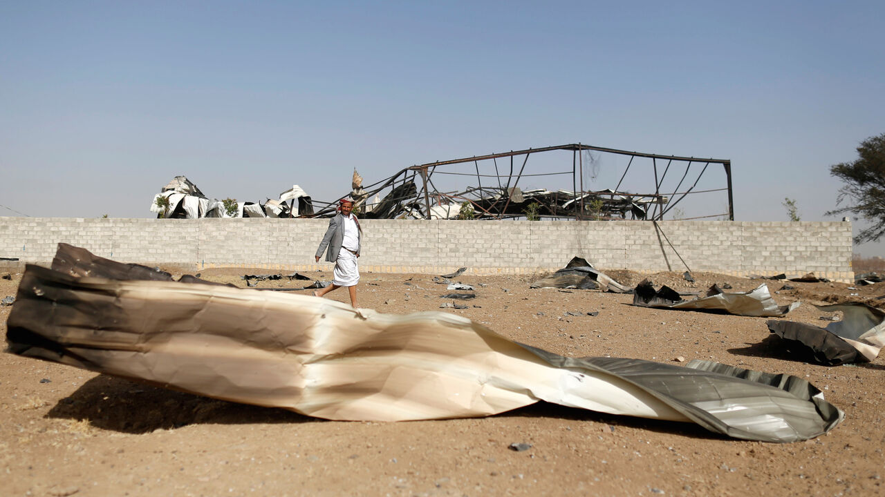 YEMEN-SECURITY/ A man walks at the site of an air strike launched by the Saudi-led coalition in the Houthi-held capital Sanaa, Yemen January 20, 2019. REUTERS/Khaled Abdullah - RC158FBC21C0