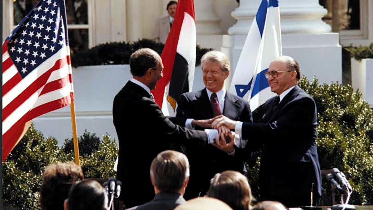 EGYPT-ISRAEL/ACCORDS FILE PHOTO: U.S. President Jimmy Carter, Egyptian President Anwar Sadat and Israeli Prime Minister Menachem Begin join hands in celebration of the signing of the ÒTreaty of Peace Between the Arab Republic of Egypt and the State of IsraelÓ at the White House in Washington, D.C., March 26, 1979. Courtesy Jimmy Carter Library/National Archives/Handout via REUTERS/File Photo ATTENTION EDITORS - THIS IMAGE WAS PROVIDED BY A THIRD PARTY. PLEASE SEARCH "FROM THE FILES - 40TH ANNIVERSARY OF EGYPT-ISRAEL PEACE TRE