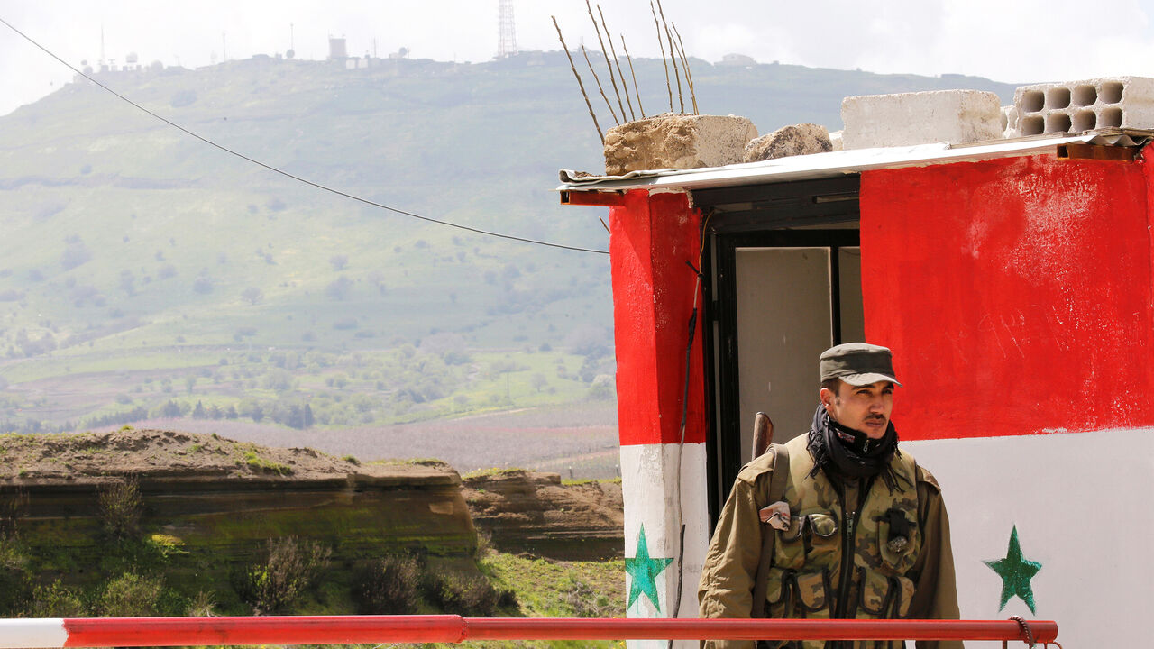 USA-ISRAEL/SYRIA-GOLAN A Syrian army soldier stands at a checkpoint at the Quneitra crossing between the Israeli-controlled Golan Heights and Syria, seen from the Syrian side in Quneitra, Syria March 26, 2019. REUTERS/Omar Sanadiki - RC1B4F2B5A00