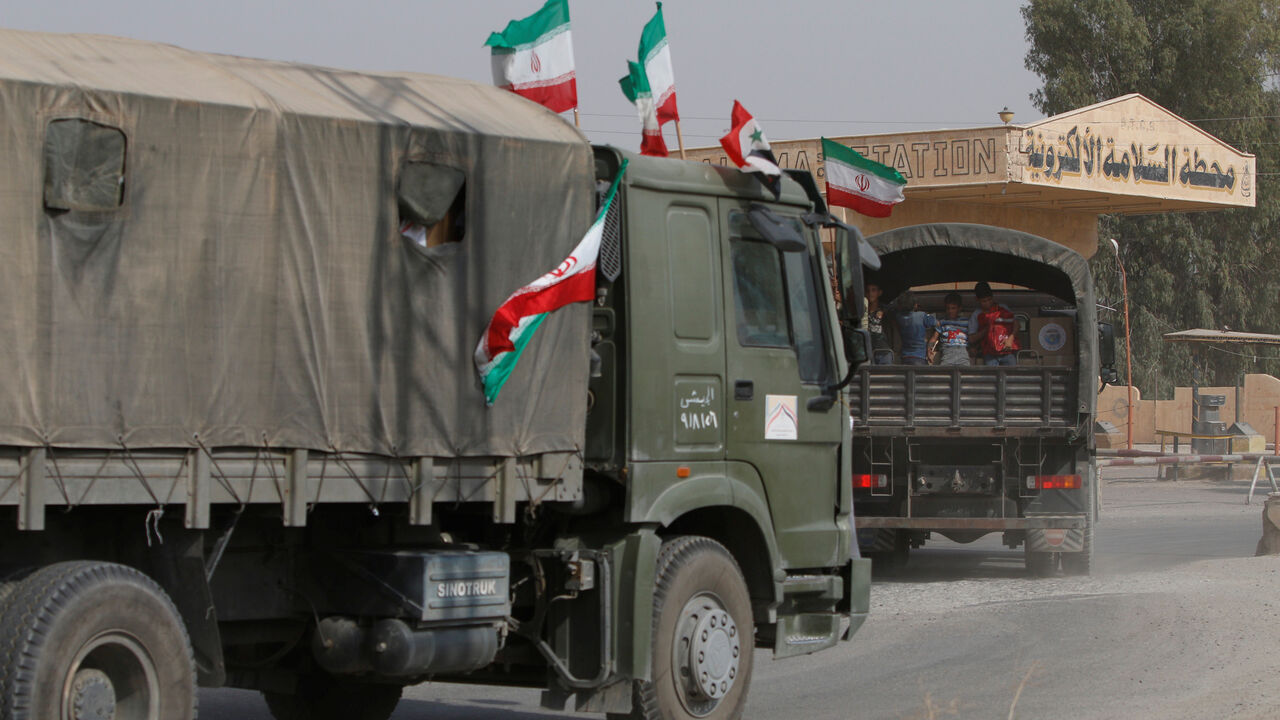 MIDEAST-CRISIS/SYRIA-DEIR AL-ZOR Iranian and Syrian flags flutter on a truck carrying humanitarian aid in Deir al-Zor, Syria September 20, 2017. Picture taken September 20, 2017. REUTERS/Omar Sanadiki - RC1C8E382200