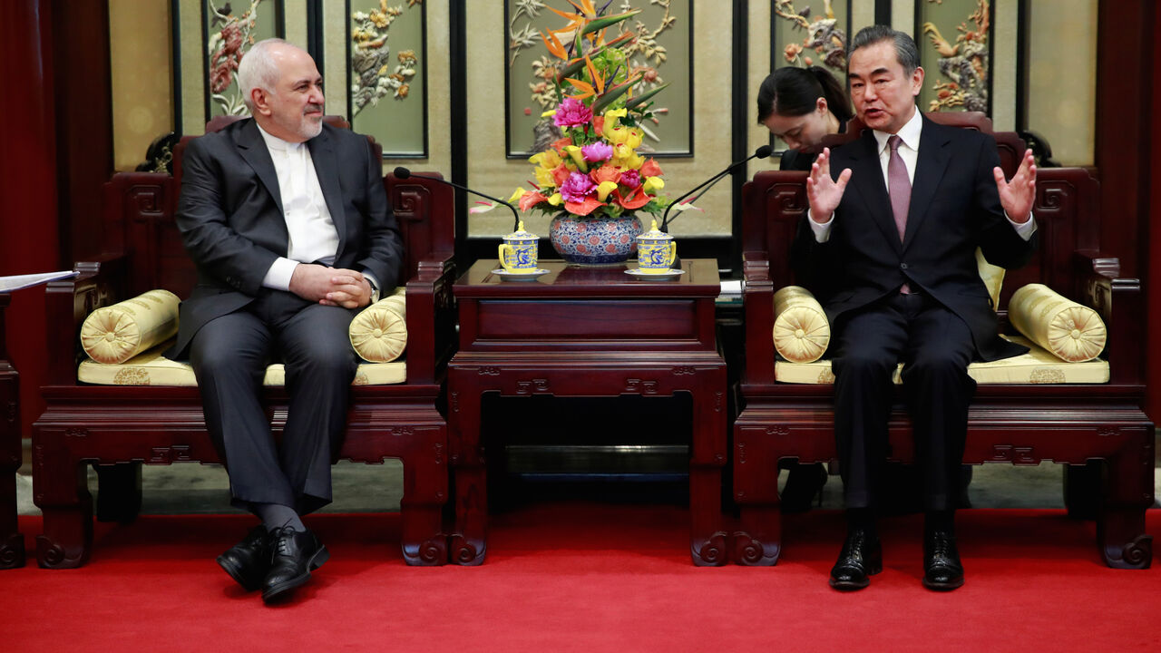 CHINA-IRAN/ Iranian Foreign Minister Mohammad Javad Zarif (L) and his Chinese counterpart Wang Yi iduring their meeting at the Diaoyutai State Guesthouse in Beijing, China February 19, 2019. How Hwee Young/Pool via REUTERS - RC12EA87AC90