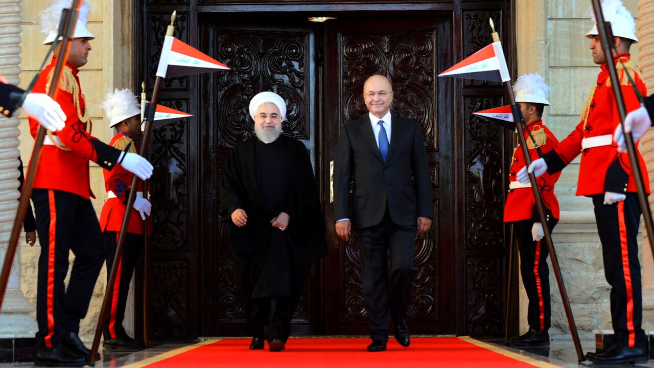 IRAQ-IRAN/ROUHANI Iraq's President Barham Salih walks with Iranian President Hassan Rouhani during a welcome ceremony at Salam Palace in Baghdad, Iraq, March 11, 2019. The Presidency of the Republic of Iraq Office/Handout via REUTERS ATTENTION EDITORS - THIS IMAGE WAS PROVIDED BY A THIRD PARTY. - RC14E2C02AD0
