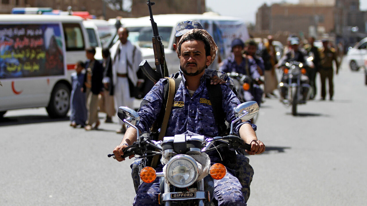 YEMEN-SECURITY/ A Houthi security officer rides a motorbike during a funeral of people killed by an air strike last week in the northwestern province of Hajja, in Sanaa, Yemen March 14, 2019. REUTERS/Mohamed al-Sayaghi - RC1B7ACE3330