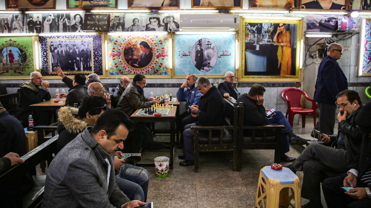 Iraqi men gather and socialise at Umm Kulthum Cafe on Rasheed street, the oldest street in the capital Baghdad on January 20, 2019. - Behind the dilapidated storefronts and collapsing colonnades of Rasheed Street lie the treasures of the Iraqi capital's cultural boom years but with young Iraqis listening to modern music and spending hours in hipster-style coffee shops, the boulevard that bustled non-stop in the 1970s is at risk of being passed over. (Photo by SABAH ARAR / AFP)        (Photo credit should re