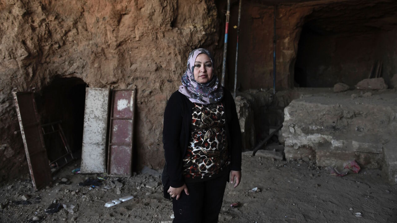 AFP_ME9NS Layla Salih, head of Antiquities for the province of Nineveh, of which Mosul is the capital, poses in front of an underground tunnel in east Mosul on March 6, 2017.
Two winged bulls dating from the Assyrians empire were found in a labyrinth of narrow underground tunnels dug by the Islamic State group in east Mosul. The impressive maze of tunnels dug by the jihadists to carry out archaeological excavations is located in the heart of the hill that houses the tomb of the Prophet Jonah (Nabi Younes). / AFP PHO