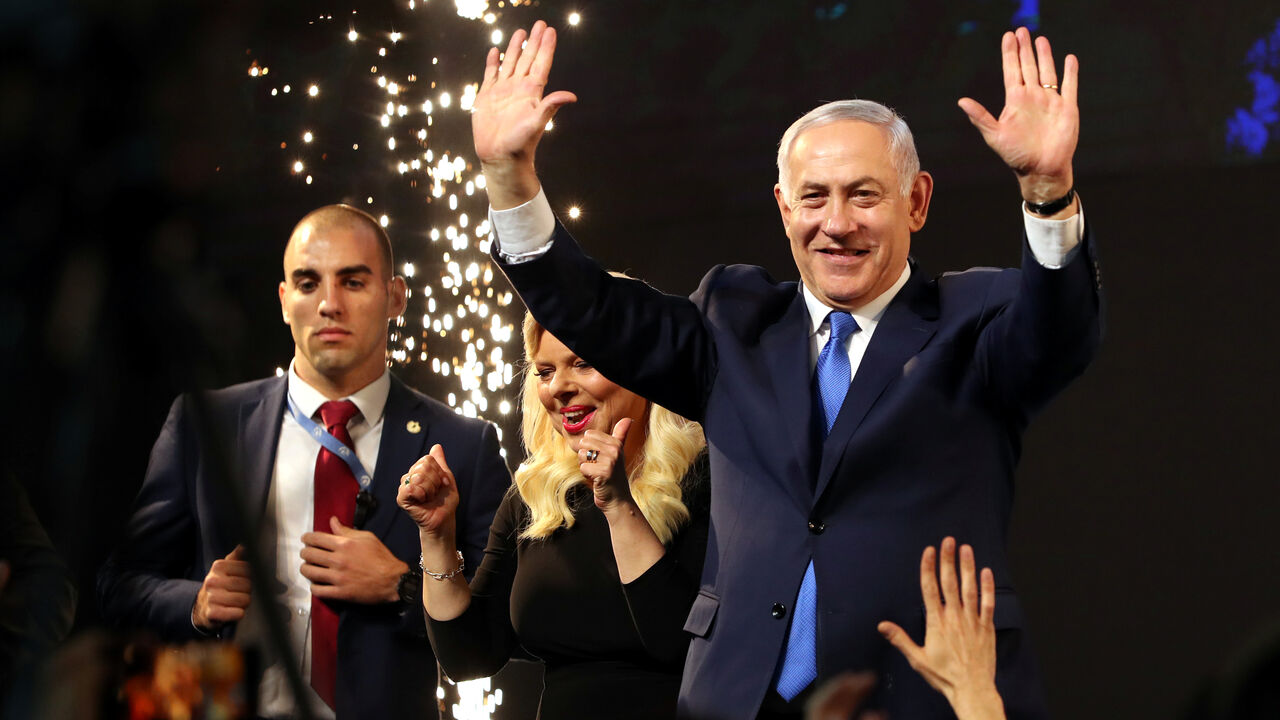 Israeli Prime Minister Benjamin Netanyahu and his wife Sara react as they stand on stage following the announcement of exit polls in Israel's parliamentary election at the party headquarters in Tel Aviv, Israel Israeli Prime Minister Benjamin Netanyahu and his wife Sara react as they stand on stage following the announcement of exit polls in Israel's parliamentary election at the party headquarters in Tel Aviv, Israel April 10, 2019. REUTERS/Ammar Awad - RC195587B720