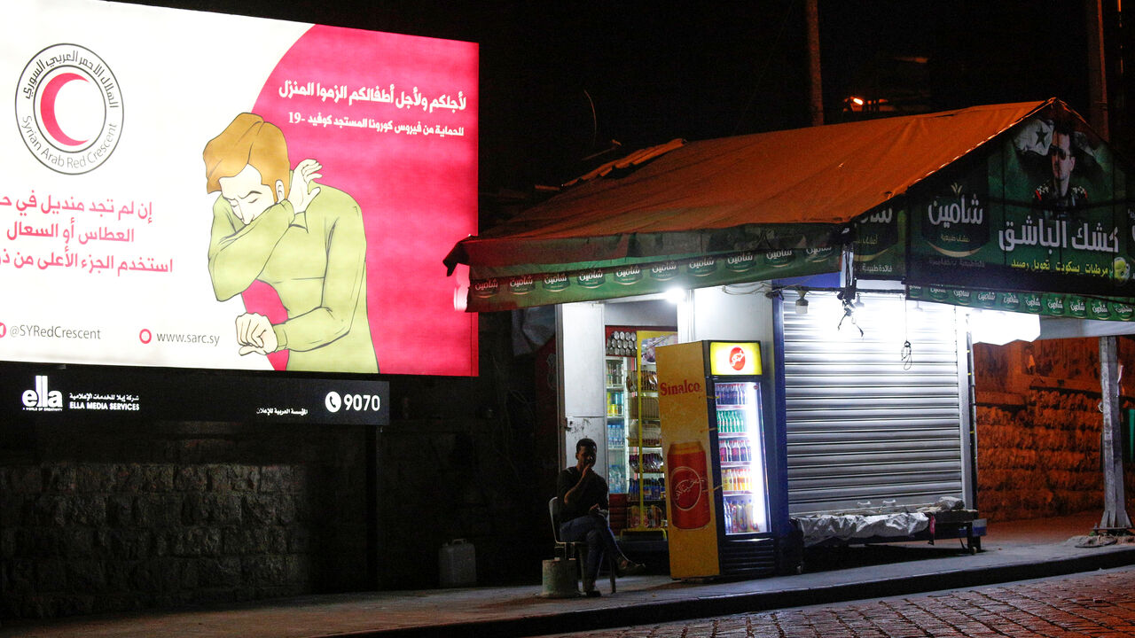 A man sits near a coronavirus awareness billboard in Damascus A man sits near a coronavirus awareness billboard, during a lockdown to prevent the spread of coronavirus disease (COVID-19), in Damascus, Syria, April 4, 2020. Picture taken April 4, 2020. REUTERS/Omar Sanadiki - RC2YXF91PSOD