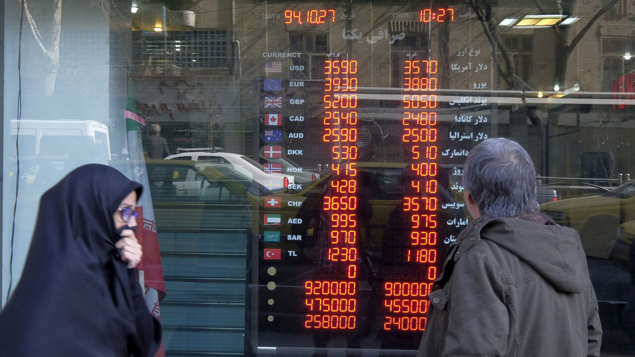IRAN-NUCLEAR/ECONOMY A man looks at exchange rates seen through the window of a currency exchange shop in Tehran's business district, Iran, January 17, 2016. REUTERS/Raheb Homavandi/TIMA ATTENTION EDITORS - THIS IMAGE WAS PROVIDED BY A THIRD PARTY. FOR EDITORIAL USE ONLY. - GF20000097685