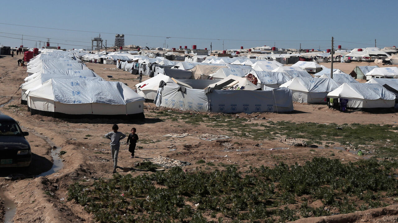 MIDEAST-CRISIS/ISLAMIC STATE-CAMP Boys walk at al-Hol displacement camp in Hasaka governorate, Syria March 8, 2019. REUTERS/Issam Abdallah - RC1FE9B01970