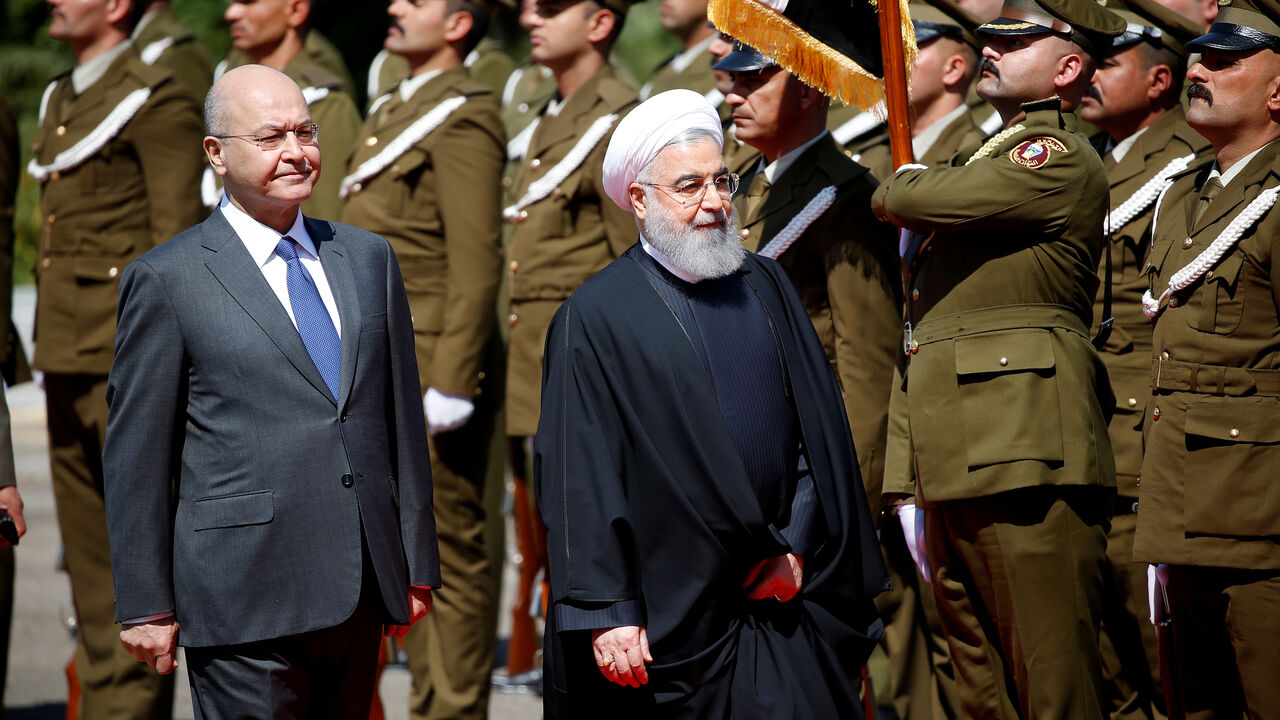 IRAQ-IRAN/ROUHANI Iraq's President Barham Salih walks with Iranian President Hassan Rouhani during a welcome ceremony at Salam Palace in Baghdad, Iraq March 11, 2019. REUTERS/Thaier al-Sudani - RC1C55FF7D70
