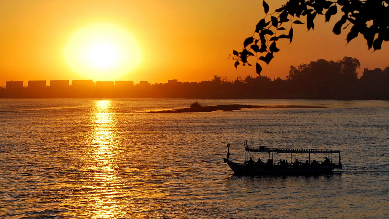 101615556 The sun sets over the Nile River in Aswan 1,000 kms south of Cairo on May 13, 2010. Four African countries signed on May 14, 2010 a new treaty on the equitable sharing of the Nile waters despite strong opposition from Egypt and Sudan who have the lion's share of the river waters. AFP PHOTO/AMGAD FOUAD (Photo credit should read AMGAD FUAD/AFP/Getty Images)