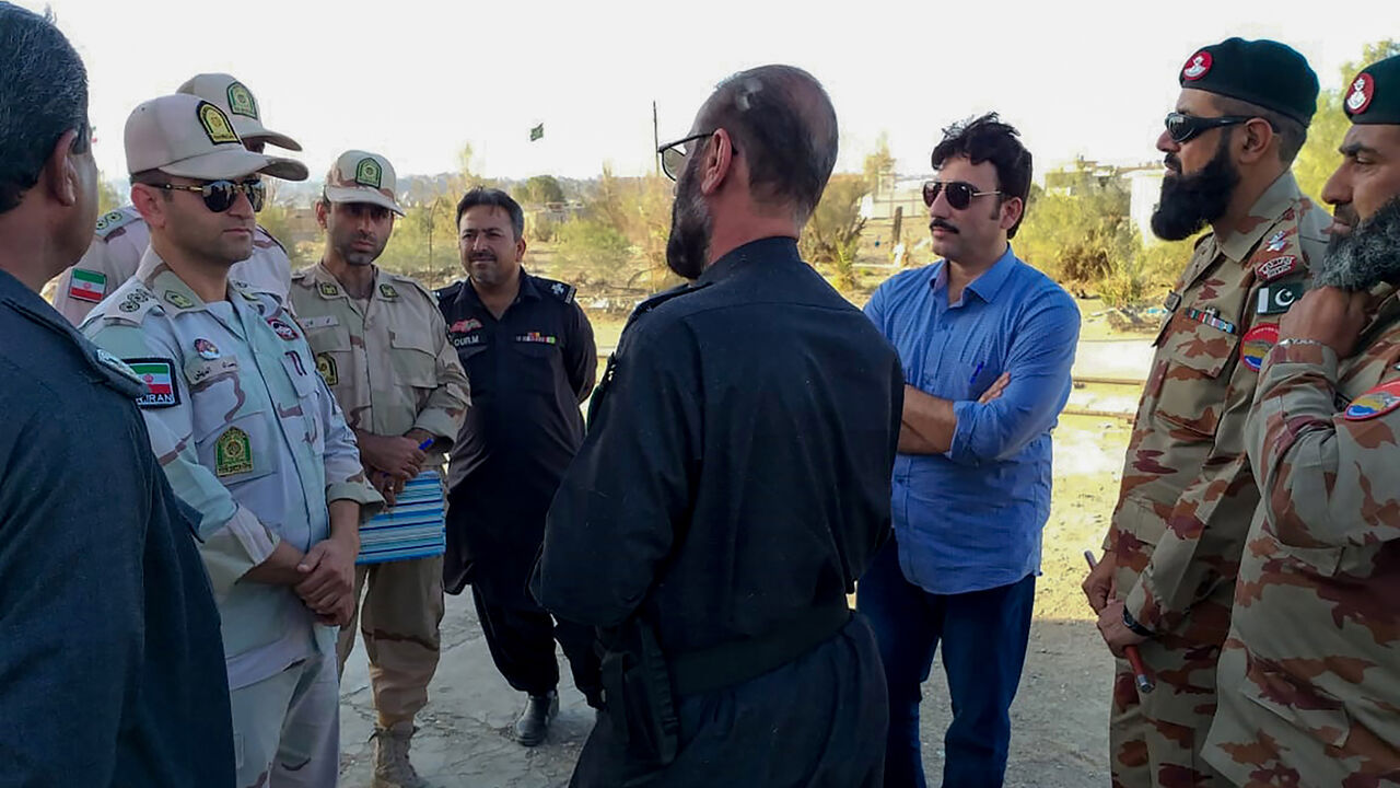 1138723179 In this picture taken on April 21, 2019, Pakistani border security officials (R) and Iranian border security officials (L) meet at Zero Point at the Pakistan-Iran border in Taftan. - Iran and Pakistan have agreed to set up a joint border "reaction force" following a number of deadly attacks by militant groups on their frontier, Iranian President Hassan Rouhani announced April 22 after talks with visiting Pakistani Prime Minister Imran Khan. (Photo by STR / AFP) (Photo credit should read STR/AFP/Getty