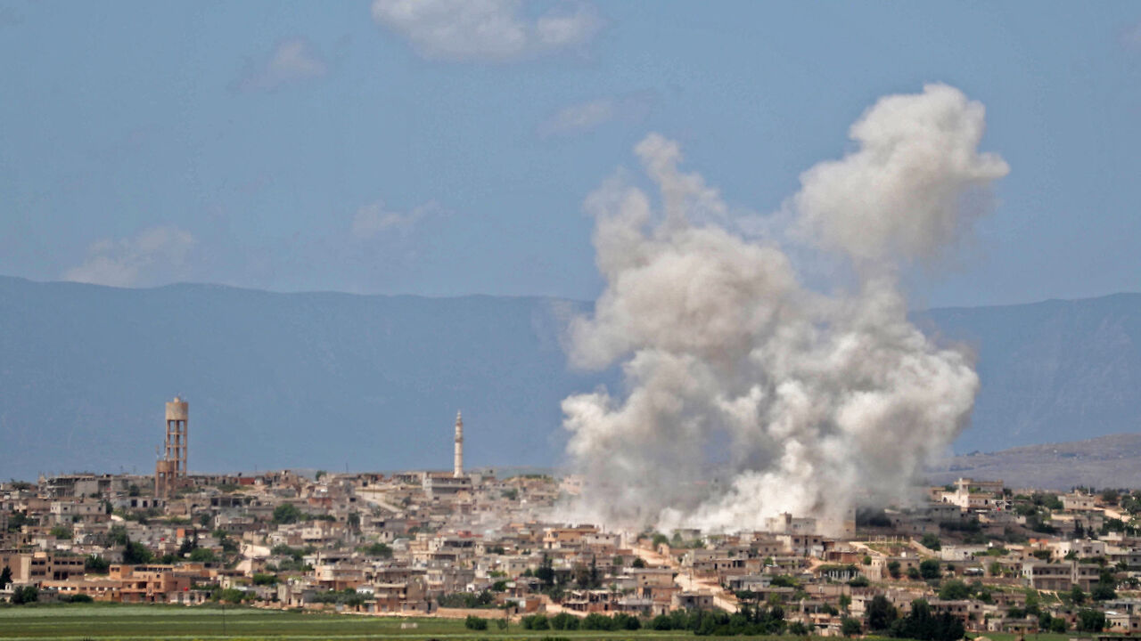 1140912164 Smoke billows above building during reported shelling by government and allied forces, in the town of Hbeit in the southern countryside of the rebel-held Idlib province on May 3,2019. (Photo by OMAR HAJ KADOUR / AFP) (Photo credit should read OMAR HAJ KADOUR/AFP/Getty Images)