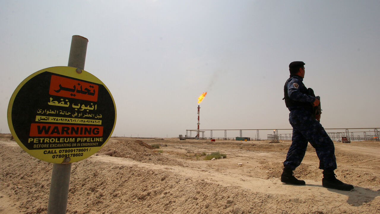 IRAQ-OIL/EXXON MOBIL A member of the oil police force guards the entrance of the West Qurna-1 oil field, which is operated by Exxon Mobil, near Basra, Iraq, May 20, 2019. Picture taken May 20, 2019. REUTERS/Essam Al-Sudani - RC17690F9600