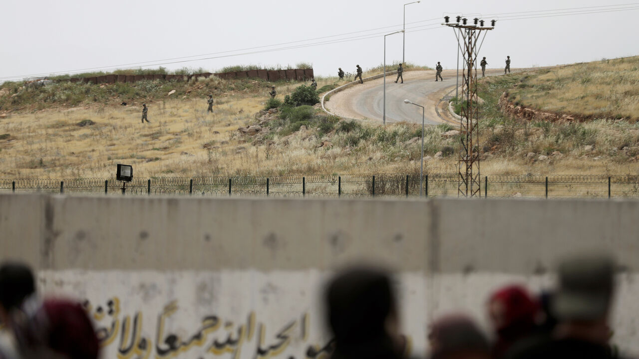 TURKEY-RUSSIA/SYRIA Turkish soldiers walk at the Atmeh crossing on the Syrian-Turkish border, as seen from the Syrian side, in Idlib governorate, Syria May 31, 2019. REUTERS/Khalil Ashawi - RC17B93A8C20