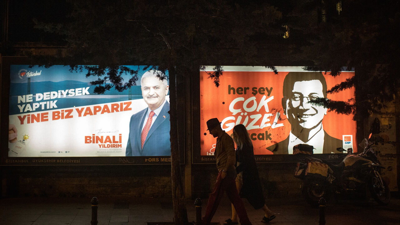 1153340116 ISTANBUL, TURKEY - JUNE 01: People walk past election posters of AK Parti candidate Binali Yildirim (L) and CHP Party, candidate Ekrem Imamoglu (R) during campaigning in the re-run of the Istanbul mayoral election on June 01, 2019 in Istanbul, Turkey. Imamoglu won a narrow victory during the first mayoral election held in March, defeating the candidate from President Erdogan's Justice and Development Party (AKP). But Turkey’s election body annulled the result after claims of “irregularities,” and Imam