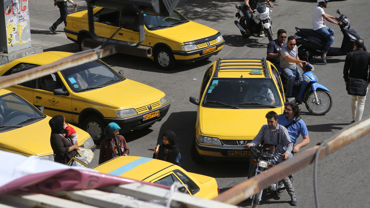 684419460 Iranians navigate the traffic in the capital Tehran on the eve of the presidential elections on May 18, 2017. / AFP PHOTO / ATTA KENARE (Photo credit should read ATTA KENARE/AFP/Getty Images)