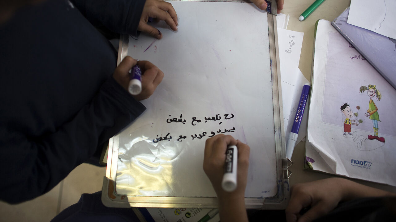 Second grade school children practise their Arabic at the Hand in Hand Arab Jewish bilingual school in Jerusalem December 3, 2014. The Hand in Hand school in Jerusalem presents an almost too-perfect scene in a tense and divided city, where Jews and Arabs do daily business but rarely befriend one other. REUTERS/Ronen Zvulun (JERUSALEM - Tags: POLITICS CIVIL UNREST EDUCATION) - GM1EAC31TX701