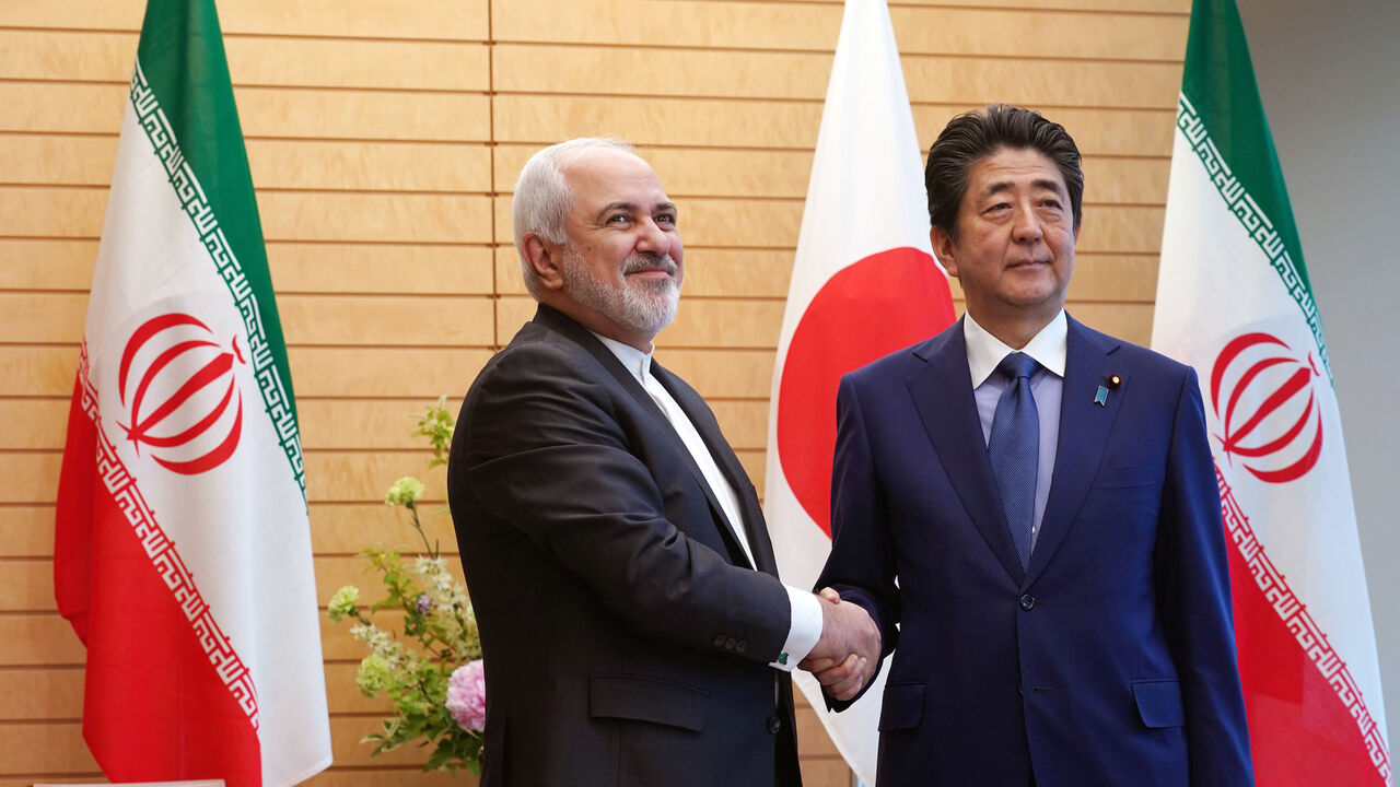 JAPAN-IRAN/ZARIF Iranian Foreign Minister Mohammad Javad Zarif, left, and Japanese Prime Minister Shinzo Abe, right, shake hands at Abe's official residence in Tokyo Thursday, May 16, 2019. Eugene Hoshiko/Pool via REUTERS - RC114BAC3050