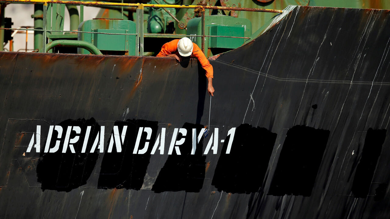 MIDEAST-IRAN/TANKER-GIBRALTAR A crew member takes pictures with a mobile phone on Iranian oil tanker Adrian Darya 1, previously named Grace 1, as it sits anchored after the Supreme Court of the British territory lifted its detention order, in the Strait of Gibraltar, Spain, August 18, 2019. REUTERS/Jon Nazca TPX IMAGES OF THE DAY - RC1491345A00