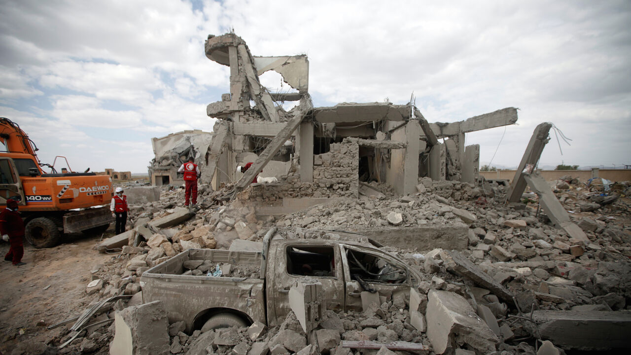 YEMEN-SECURITY/DHAMAR Destroyed car is seen between rubble as Red Crescent medics inspect the site of Saudi-led air strikes on a Houthi detention centre in Dhamar, Yemen, September 1, 2019. REUTERS/Mohamed al-Sayaghi - RC15DB729000