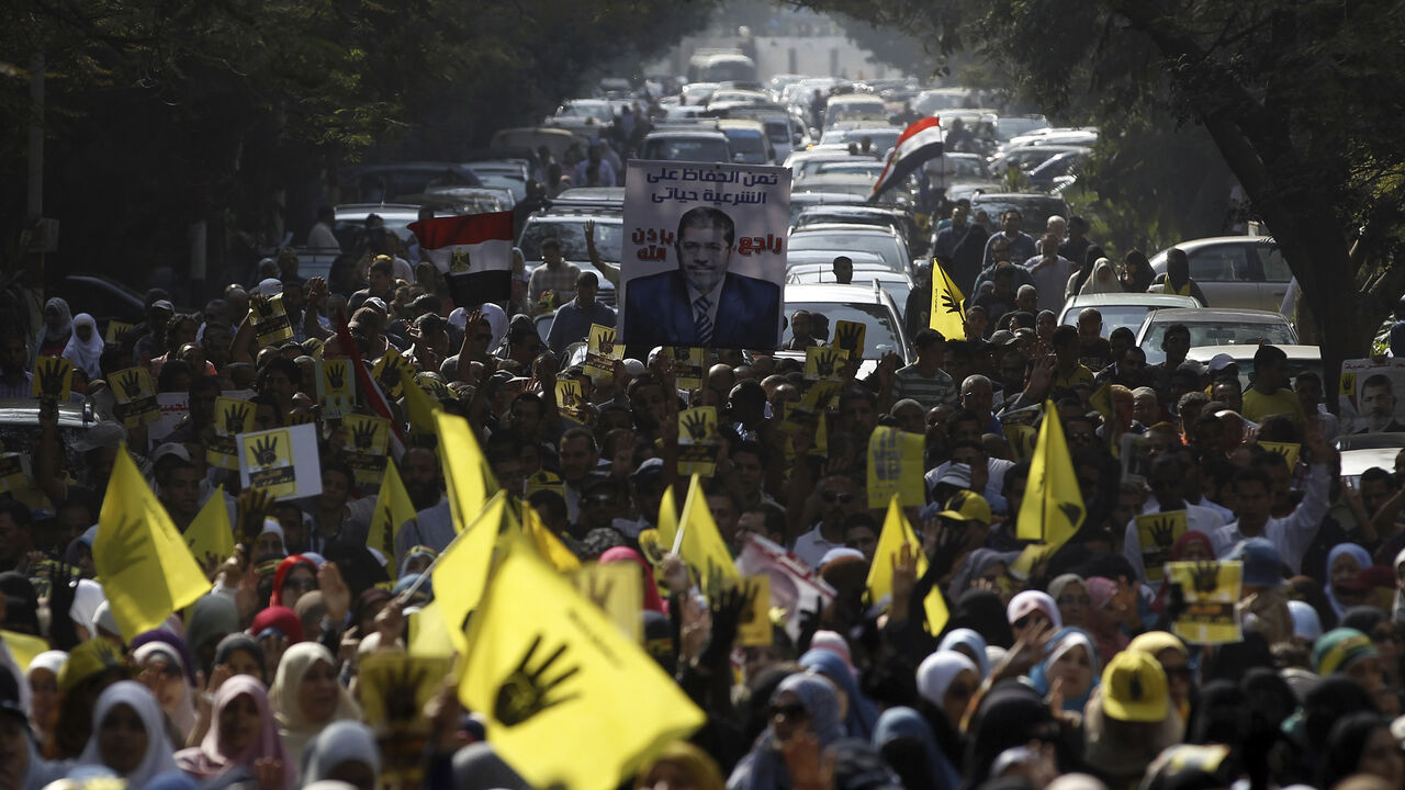 EGYPT-PROTESTS/ Supporters of the Muslim Brotherhood and ousted Egyptian President Mohamed Mursi take part in a protest against the military and interior ministry in the southern suburb of Maadi, on the outskirts of Cairo November 1, 2013. U.S. Secretary of State John Kerry will visit Egypt a day before deposed Islamist President Mohamed Mursi goes on trial, the next likely flashpoint in the struggle between his Muslim Brotherhood and the army-backed interim government. Several hundred Islamists protested in a few cities o