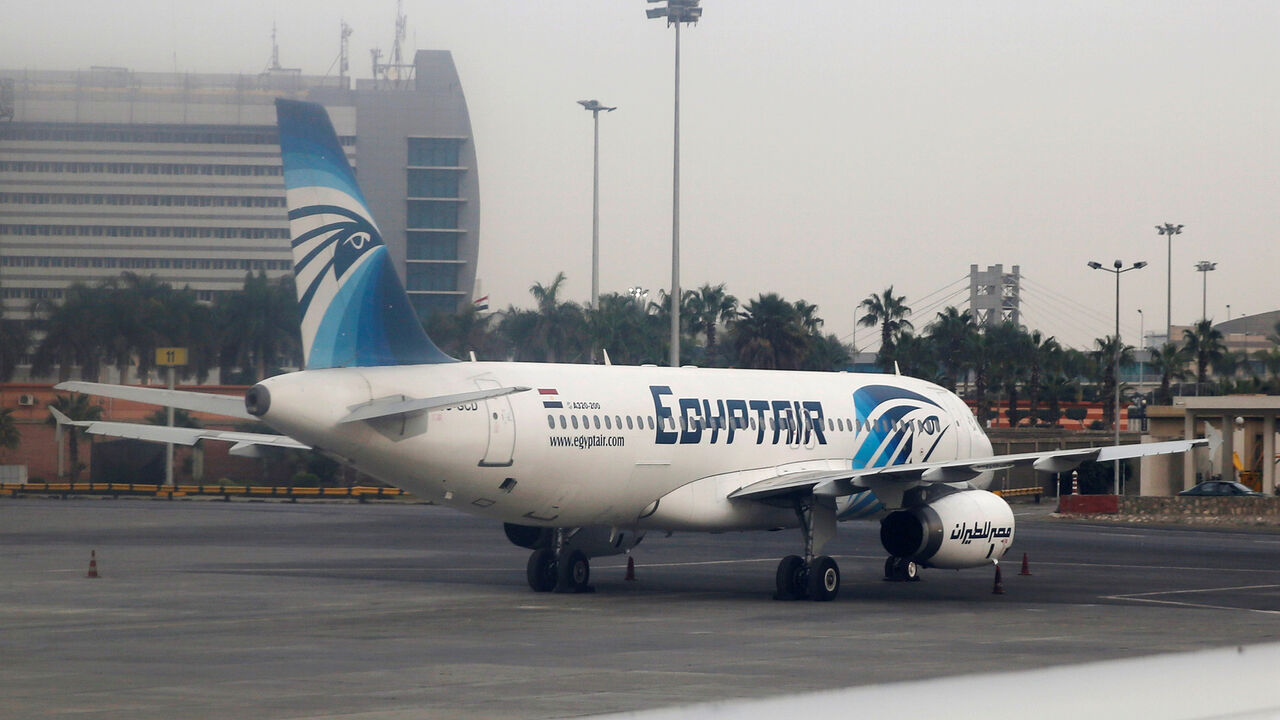 GLOBAL-AIRLINES/ An EgyptAir A320-200 plane is pictured through the window of an Etihad Airways plane after it landed on the runway at Cairo International Airport, Egypt December 16, 2017. Picture taken December 16, 2017. REUTERS/Amr Abdallah Dalsh - RC140A9C9210